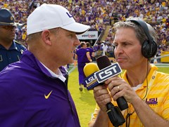Franques, working as football radio sideline reporter in 2013, interviews (former) football coach Les Miles.